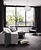 Sofa set in purist grey next to large living room window