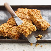 Flapjacks on a baking tray with a pallet knife