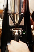 A barista grinding coffee