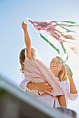 Mother and daughter playing with a kite