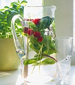 Herb-infused water with raspberries