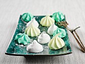 Colourful marshmallows bites on green plate