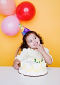Portrait of young girl with birthday cake