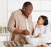 Senior woman making cookies with her granddaughter