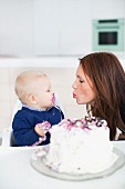 Boy with mother celebrating first birthday