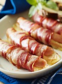 Frankfurter sausages stuffed with cheese and wrapped in bacon
