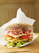 Burger with ham, cheese and tomatoes