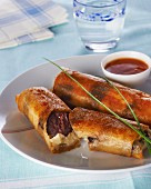 Black pudding wrapped in pastry, with chilli sauce