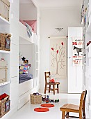 Radiant, white child's room with built in bunk beds, wall shelving and vintage chairs