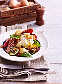 Vegetable salad with grilled bacon and poached egg