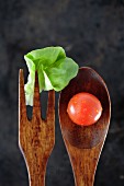 Wooden fork and spoon with lettuce and tomato