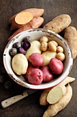 Verschiedene Kartoffelsorten in & neben Emailleschüssel
