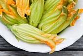 Several courgette flowers on a plate