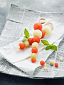 Melon skewers on a paper napkin