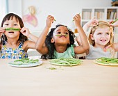 Girls playing with green beans