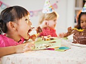 Girls enjoying cake at birthday party