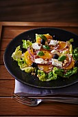 Orange salad with goat's cheese, olives and hazelnuts