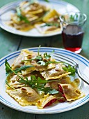 Ravioli with beetroot filling, pine nuts and rocket