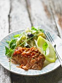 A serving of baked salmon with crisp topping
