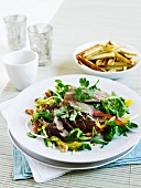 Beef salad with vegetables, coriander leaves and yam chips (Asian)