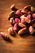 Shelled pistachios on a wooden surface