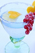 'Cold Duck' punch in a glass with a sugared rim, decorated with a heart made from lemon peel and with candied redcurrants