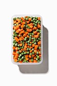 Frozen peas and carrots in container