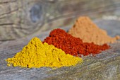Three mounds of different spices