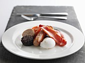 English Breakfast with sausage, bacon, fried tomato, black pudding, white pudding and poached egg