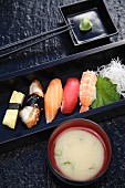 Nigiri sushi with wasabi and miso soup
