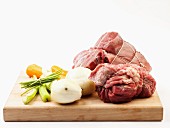 Fresh beef and soup vegetables on a chopping board