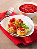 Ebelskiver (Danish apple cakes) with peach and redcurrant sauce