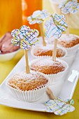 Lemon muffins with wooden skewers decorated with flower shapes punched out of map