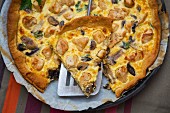 Mushroom quiche with parsley, sliced