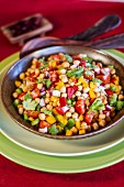 Vegan chickpea salad with tomatoes, peppers and coriander leaves