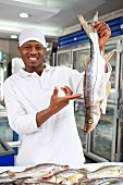 A fish monger with fresh fish