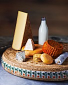 Various types of cheese with milk and crackers