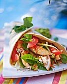 A chicken, tomato and avocado wrap