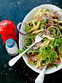 Pasta salad with salami and rocket