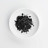 A plate of black sea salt grains