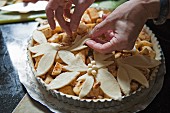 Baker Adding Leaf Cutouts to Apple Pie