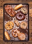 Assorted Glazed Donuts on Cookie Sheet, High Angle View