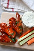 Buffalo chicken wings accompanied by carrots, celery and ranch dipping sauce
