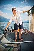 Fisherman standing in boat holding nets