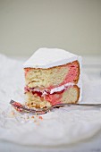 Slice of strawberry cake decorated with white sugar cream