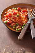 Chicken breast in tomato sauce with peas