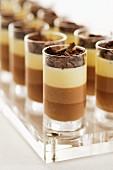 Tricoloured chocolate mousse in glasses