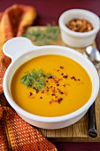 Cream of pumpkin soup with chilli and fennel leaves