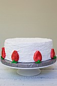 A strawberry cake with vanilla icing