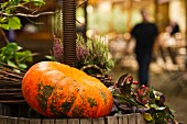 Autumnal garden decoration with a pumpkin and heather